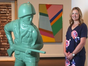 Melanie Kjorlien, curator of Glenbow at 50, poses in the exhibit area Wednesday September 28, 2016. She is beside Green Soldier No. 1, from 2001 by Douglas Coupland. (Ted Rhodes/Postmedia Calgary)