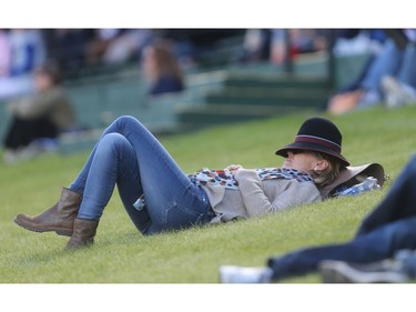 Christina Harbich from Brazil relaxes on the grass watching the afternoon competition on the International Ring at Spruce Meadows on the opening day of The Masters Wednesday September 7, 2016.  Her daughter Karina Johannpeter competed in the morning's event, the Telus Cup.