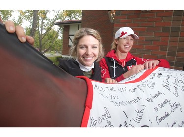 Olympians Tiffany Foster, left, and Amy Millar, pose beside a blanket signed by members of the public wishing Team Canada well before the Rio Olympics Tuesday September 6, 2016 at Spruce Meadows. Spruce Meadows is gearing up to close the season with this week's The Masters.
