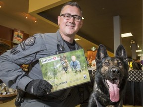 Sgt. Jim Gourley and his dog Max show off the new Calgary Police Service Canine Unit calendar at the Crowfoot Safeway in Calgary, Alta., on Thursday, Sept. 22, 2016. They were launching their 2017 calendar; proceeds from calendar sales benefit the Calgary Police Foundation.