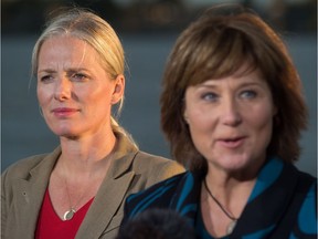Catherine McKenna, left, Minister of Environment and Climate Change, listens as British Columbia Premier Christy Clark speaks after the federal government announced approval of the Pacific NorthWest LNG project.