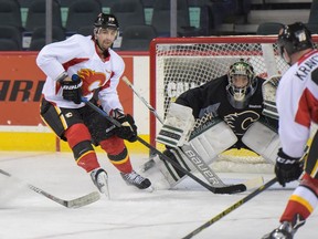 Chris Higgins and goaltender Tyler Parsons anticipate a shot during the Calgary Flames training camp on Saturday, Sept. 24, 2016. Elizabeth Cameron/Postmedia