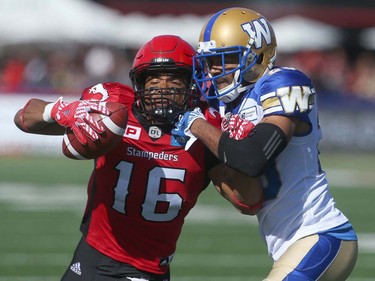 Stampeders Marquay McDaniel (L) battles Blue Bombers Johnny Adams (R) during CFL action between the Calgary Stampeders and the Winnipeg Blue Bombers in Calgary, Alta.. on Saturday September 24, 2016. Jim Wells/Postmedia