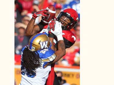 Stampeders Kamar Jorden tries to haul in a catch in front of Blue Bomber defender Tony Burnett during CFL action between the Calgary Stampeders and the Winnipeg Blue Bombers in Calgary, Alta. on Saturday September 24, 2016. Jim Wells/Postmedia
