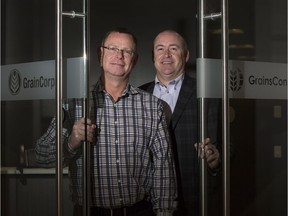 Warren Stow, president GrainsConnect, right, with Robert Fullerton, North America trading director, GrainCorp, hold open the doors of their new Quarry Park shared location.
