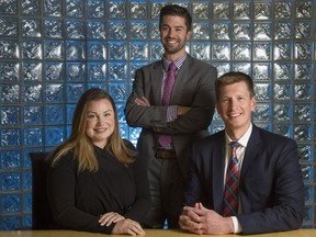 Sean McLean, right, managing partner of Heidrick & Struggles, Kaity Hutchison, executive assistant, left, and Geoff Prieur, associate, in their Calgary office.