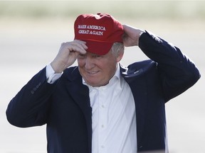Republican presidential candidate Donald Trump wears his "Make America Great Again" hat at a rally in Sacramento, Calif.