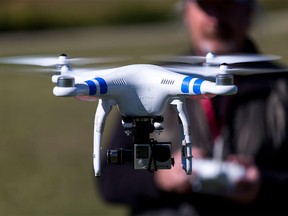A DJI Phantom II drone flies recreationally in a rural area near Calgary on Tuesday, Sept. 22, 2015.