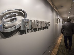 CALGARY, AB -- An Enbridge employee walks past signage at the head office in Calgary, on September 6, 2016. --  (Crystal Schick/Postmedia) (For  story by  )