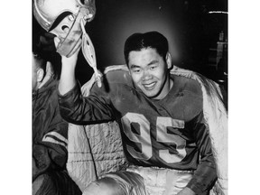 FILE - Former CFL fullback Norman "Normie" Kwong is seen in Edmonton Eskimos regalia in an undated file photo. THE CANADIAN PRESS