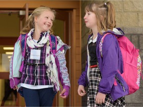 Madison Kingma, 6, and her friend Sara Mackenzie, 6, were excited to start Grade 2 on the opening day of Copperfield School in Calgary, Alta., on Tuesday, Sept. 6, 2016.