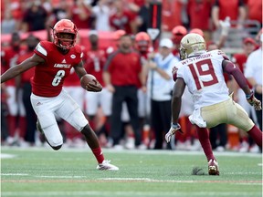 Lamar Jackson, left, of the Louisville Cardinals runs past A.J. Westerbrook of the Florida State Seminoles duriing the fourth quarter of the game at Papa John's Cardinal Stadium on September 17, 2016 in Louisville, Kentucky.