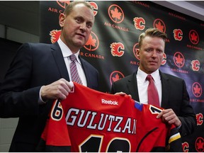 Calgary Flames' general manager Brad Treliving, left, named Glen Gulutzan as the team's new head coach at a news conference in Calgary, Friday, June 17, 2016.