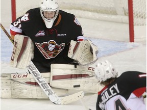 Goalie Cody Porter from the Calgary Hitmen keeps an eye on a shot from Colby McAuley from the Prince George Cougars in WHL hockey action in Calgary, Alta. on Wednesday November 18, 2015.