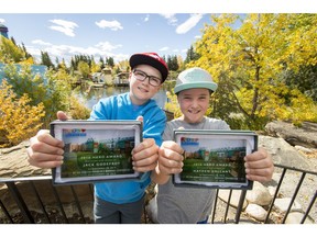 Jack Godefroy (L) and his cousin and best friend Hayden Gallant show off their Hero Awards from the Alberta Children's Hospital Foundation at Calaway Park west of Calgary, Alta., on Sunday, Sept. 18, 2016. Godefroy is a cancer fighter; he and Gallant raised $4,000 for the foundation in a head-shaving event and were at Calaway Park for the foundation's Kids Helping Kids celebration. Lyle Aspinall/Postmedia Network