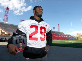 Jamar Wall poses and holds a fan-made plaque following Calgary Stampeders' practice in Calgary, Alta at McMahon Stadium on Tuesday September 27, 2016.  Teammate Mylan Hicks was killed at a shooting outside a nightclub early Sunday morning. Wall is planning on wearing Hicks' #31 jersey in the team's upcoming game. Jim Wells//Postmedia