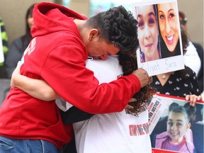 Jaylin Marsman (L) Taliyah Baillie's brother, is joined by family in Calgary, Alta during the Walk for Justice on Saturday September 10, 2016. About 100 supporters joined the Walk for Justice from the 13 Ave and 1 St SW to the court house downtown then returned to the location where Aaron Shoulders was murdered. Jim Wells//Postmedia]