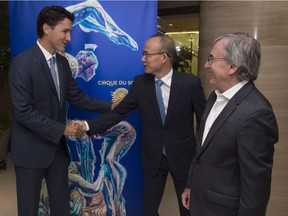 Canadian Prime Minister Justin Trudeau shakes hands with Chairman of the Bosun Group Guo Guangchang, centre, as Cirque de Soleil CEO Daniel Lamarre looks on before a meeting in Shanghai, China, Friday, Sept. 2, 2016.
