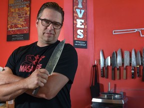 Kevin Kent poses inside Knifewear, one of several related stores he owns in Calgary.