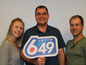 Jerry Krivoshen, centre, with daughter Jennifer and her fiance Jarrett Dooley won $1 million on the Aug. 13 Lotto 6/49 guaranteed prize draw.