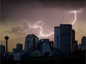 Lightning punctuates the downtown skyline in Calgary, Alta., on Monday, Aug. 29, 2016. A small and brief rolled over the city just after sunset. Lyle Aspinall/Postmedia Network