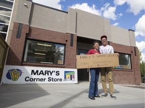 CALGARY, AB -- Jade Tea, left, and her son Sam Cheung stand in front of their corner store, Mary's in Calgary, on September 7, 2016, which is finally reopening after it was destroyed by the Alberta Floods in 2013. --  (Crystal Schick/Postmedia) (For City story by  Annalise Klingbeil)