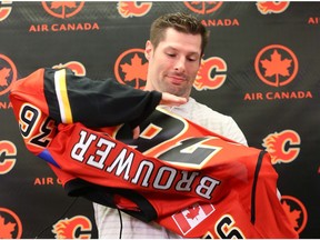 Newly acquired Troy Brouwer tries on the Flames jersey as the Calgary Flames announced the signing in Calgary, Alta on Friday July 1, 2016.