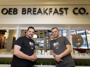 Mauro Martina (L) and Scott Adamson of OEB Breakfast Co. pose for a photo in their downtown location in Calgary.