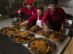 Mahmut Elbasi, chef and owner Anatolia Turkish Food, left, dresses some  stuffed lamb and rice with his kitchen staff, Ali Selim, centre, and Ahmet Erdogan, in the kitchen of the new restaurant across from Olympic Plaza in downtown Calgary.