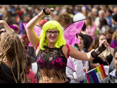 A dancer enjoys a festival after the Calgary Pride Parade in the city's downtown core on Sunday, Sept. 4, 2016. About 60,000 people were expected to watch the annual parade, as more than 125 entries took part. Lyle Aspinall/Postmedia Network
