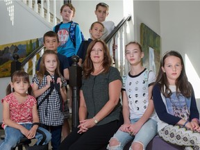 Lisa Davis, centre, past president of Calgary Association of Parent and School Councils, photographed at her home in Calgary, Alta., with (L-R) Cora Bieber, Halle Bieber, Elliot Thomsen, Robert Davis, Kai Bieber, Diana Davis, and Madeleine Thomsen, on Saturday, Sept. 3, 2016. Davis is concerned about Alberta's curriculum, particularly the low level of math and science opportunities for kids like group gathered here.