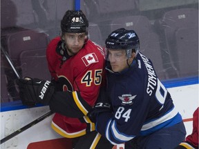 PENTICTON, BC. SEPTEMBER 14, 2015 -Morgan Klimchuk of the Calgary Flames prospects is rubbed out by Peter Stoykewych of the Winnipeg Jets  at the South Okanagan Events Centre in Penticton.  Shaughn Butts/Edmonton Journal