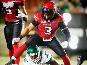 Calgary Stampeders Taylor Reed celebrates after bring down  quarterback Darian Durant of the Saskatchewan Roughriders during CFL football in Calgary, Alta., on Thursday, August 4, 2016.