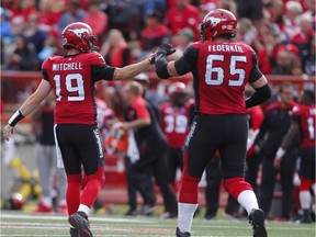 Calgary Stampeders Bo Levi Mitchell and Dan Federkeil celebrate after a touchdown by Jerome Messam against the Ottawa Redblacks during CFL football in Calgary, Alta., on Saturday, September 17, 2016.