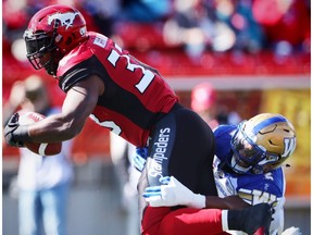 Calgary Stampeders Jerome Messam avoids a tackle by Khalil Bass of the Winnipeg Blue Bombers during CFL football in Calgary, Alta., on Friday, September 23, 2016.