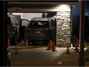Evidence marked by pylons in the driveway after a shooting on Redstone Manor N.E. in Calgary, on Sept. 20, 2016.