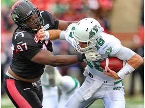 Saskatchewan Roughriders Brett Smith is sacked by Derek Wiggan of the Calgary Stampeders during CFL football in Calgary, Alta. on Saturday October 31, 2015.