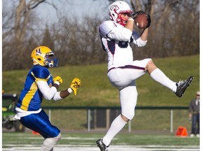 Saskatoon Hilltops defensive back Arnold Osam looks on as Calgary Colts receiver Cole Bazinet grabs a pass during the Prairie Football Conference final at SMF Field on Sunday, October 25th, 2015. The Colts are looking to make it back to the championship game this year and go on to win a national championship.