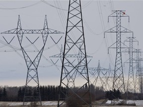 High voltage power lines carrying electricity run east west south of Spruce Grove, Alberta.