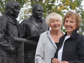 Longtime volunteers Pam Russell, left, and Anne French stand alongside the statue of the Margaret and Ron Southern.