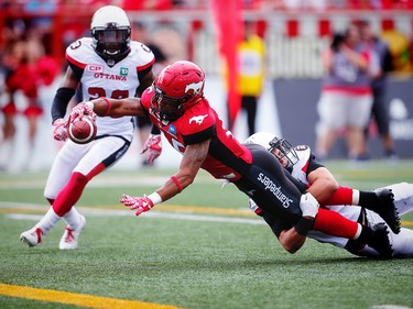 Calgary Stampeders Marquay McDaniel with a touchdown against Nick Taylor and Antoine Pruneau of the Ottawa Redblacks during CFL football in Calgary, Alta., on Saturday, September 17, 2016.