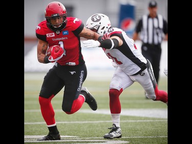 Calgary Stampeders Lemar Durant avoids a tackle by John Boyett of the Ottawa Redblacks during CFL football in Calgary, Alta., on Saturday, September 17, 2016.