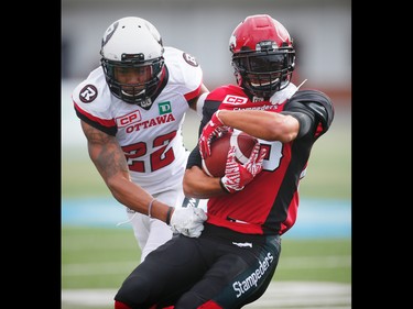 Calgary Stampeders Anthony Parker is tackled by Jeff Richards of the Ottawa Redblacks, who was called for unnecessary roughness on the play, during CFL football in Calgary, Alta., on Saturday, September 17, 2016.