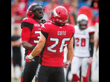 Calgary Stampeders Jerome Messam celebrates with teammate Rob Cote after his touchdown against the Ottawa Redblacks during CFL football in Calgary, Alta., on Saturday, September 17, 2016.