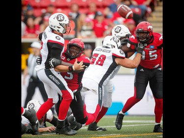 Calgary Stampeders Micah Johnson knocks the ball loose from quarterback Trevor Harris, the fumble is recovered by Ja'Gared Davis for a touchdown against the Ottawa Redblacks during CFL football in Calgary, Alta., on Saturday, September 17, 2016.