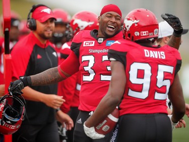 Calgary Stampeders Jerome Messam celebrates with Ja'Gared Davis on the sideline, after Davis fumble recovery for a touchdown against the Ottawa Redblacks during CFL football in Calgary, Alta., on Saturday, September 17, 2016.