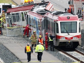Emergency workers deal with a CTrain derailment at the Tuscany LRT station in northwest Calgary on Tuesday morning.