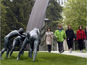 A group of students walk on the University of Calgary campus.