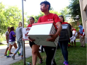 U of C students volunteer their time to help new students move into residence on campus, in August 2014. Students will start moving in for this year's school year on Sunday.