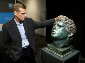 Darrell Fox stands next to a bust of his brother Terry at Canada's Sports Hall of Fame in Calgary, Alta., on Tuesday, Sept. 13, 2016. A travelling exhibit called 'Terry Fox: Running to the Heart of Canada' opened to the public. Lyle Aspinall/Postmedia Network